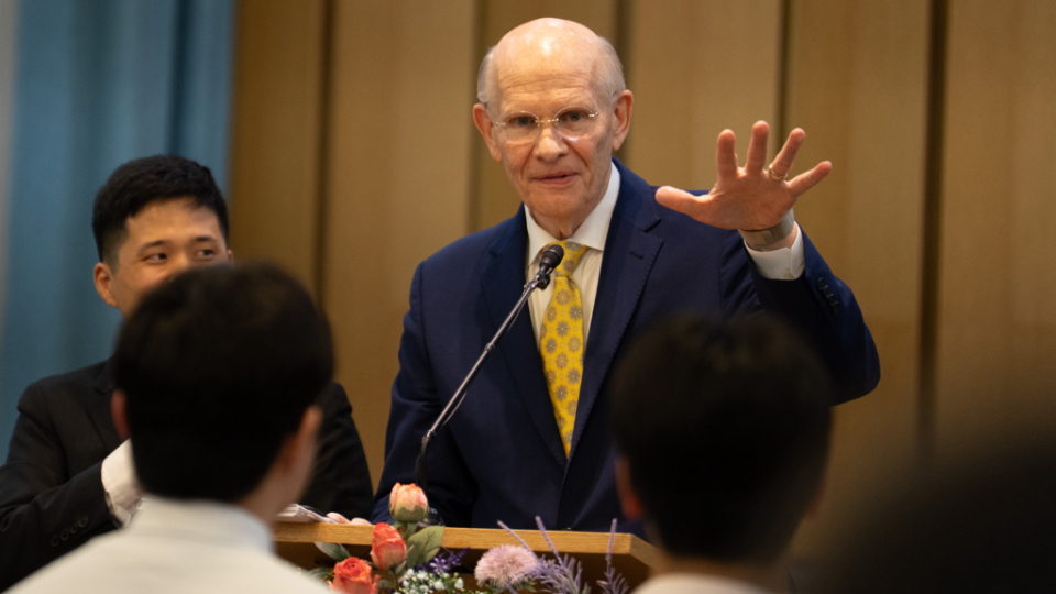 2025-ASN-05---Busan-Devotional--22-(Renlund-at-Podium-Hand-outstretched)Vest01.jpg